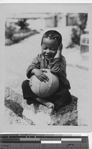 A little boy with a ball at Shangchuan, China, 1925