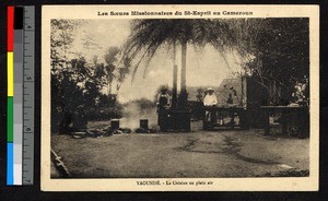 Missionary sister and man preparing food outdoors, Cameroon, ca.1920-1940