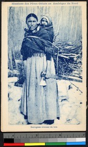 Woman carrying infant, firewood, and axe, Canada, ca.1920-1940