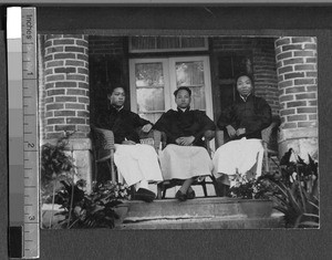 Three young men seated on a porch, Ing Tai, Fujian, China, ca. 1910