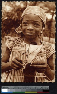 A young girl learning to knit, Omvan, Cameroon, ca.1920-1940