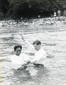 Reverend E J Ball conducting river baptism, Peru, ca. 1947