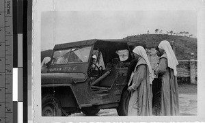 Novices looking at a jeep, Laipo, China, July 1948