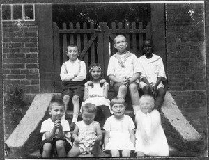 Arnold Blumer and seven other children on a staircase, Tanzania, ca. 1925-1928