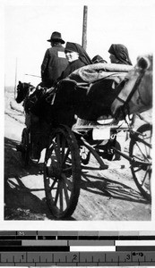 Group of Maryknoll Sisters in a horse drawn cart, Fushun, China, 1940