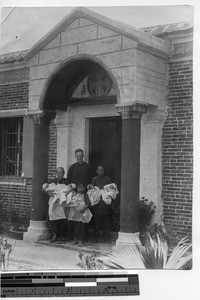 Fr. Phillip A. Taggart with a "supply of babies" at Yangjiang, China, 1929