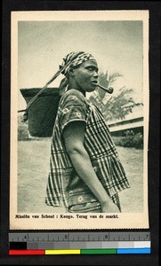 Woman with pipe carrying a load with a head strap, Congo, ca.1920-1940