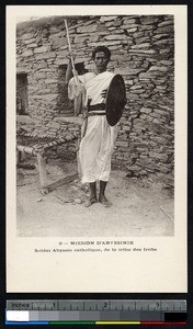 An indigenous soldier holds a shield and spear, Ethiopia, ca.1900-1930