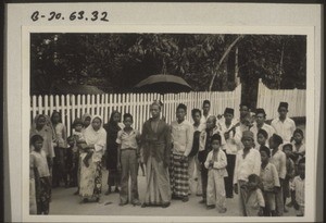 In Sukamara. An islamic wedding. The bridegroom is accompanied on the street by his friends, who surround and protect him - a sign of high honour