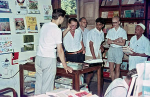 Missionary Henning Berget behind the desk in DMS Bookshop, Aden. In photo is seen Mubarak Ibrah