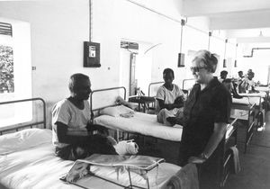 Missionary and Head Nurse, Helga Johansen with a patient at Vadathorasalur Leprosy Hospital, Ar