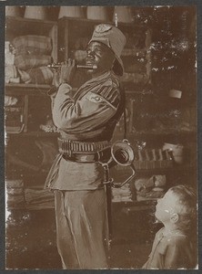 African soldier playing flute, Tanzania, ca.1902-1914