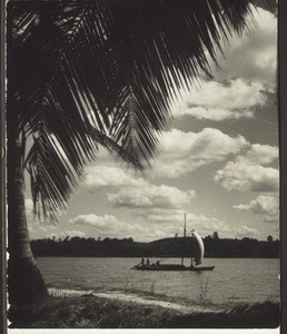 Boat on a river. There are broad rivers flowing through South Canara, and old-fashioned sailing boats carry their loads on them