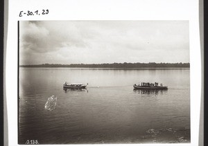 Motor-boat towing a heavily laden boat