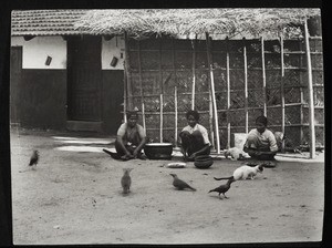 Maidservants, cleaning fish, preparing vegetables, at the boarding house