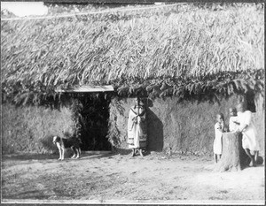 African woman with three children, Tanzania, ca. 1925-1930