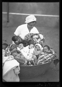 Miss Golaz with babies of the maternity ward, Chamanculo, Maputo, Mozambique, 1940