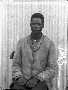 African man sitting on a chair, Pretoria, South Africa, ca. 1896-1911