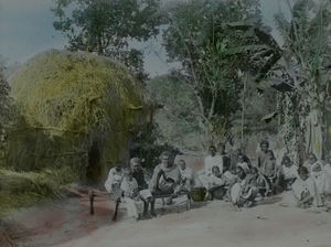 Rice straw on bamboo frame. Banana plant and some Santals sitting on the bed