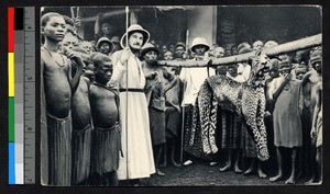 Missionary father with spear standing with dead leopard, Cameroon, ca.1920-1940