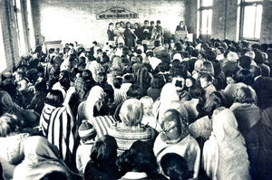 Church service of a Nepali congregation, Kathmandu, according to tradition sitting on the floor