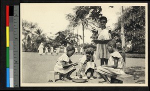 Children eating a meal outdoors, Congo, ca.1920-1940