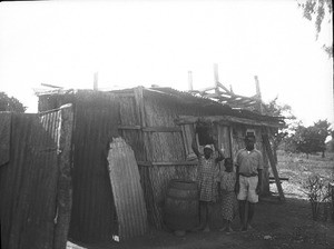 African people standing in front of a shack, southern Africa