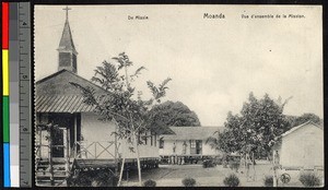 Mission housing standing near a church, Congo, ca.1920-1940