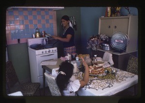 Woman and girl inside their home