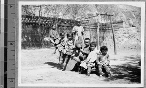 Children on see-saw at Harwood Bible Training School, Fenyang, Shanxi, China, ca.1936-37