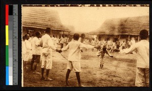 Young Christian boys playing outdoors while a missionary sister looks on, Congo, ca.1920-1940