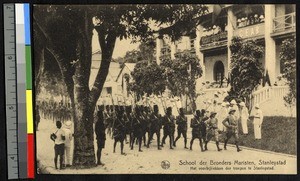 Troops march past the mission, Kisangani, Congo, ca.1920-1940