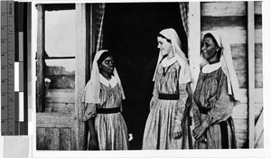 Three Catholic Sisters by the entrance of a building, Oceania, ca. 1920-1940