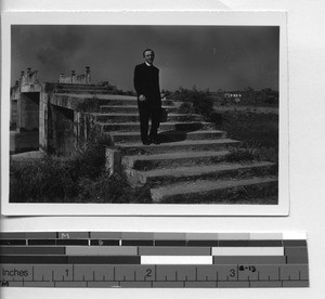 Fr. Meyer walking across a bridge in Jiangmen, China, 1948