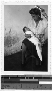 Doctor's wife holding an infant, Carrillo Puerto, Quintana Roo, Mexico, March 1946