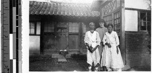 Sister Edwardine, MM, standing with an elderly Korean couple, Heijo, Korea, October 1938