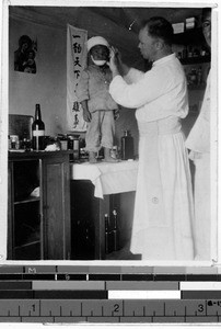 Father Hannon, MM, with a patient, Hiken, Korea, ca. 1932