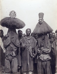 Two dancers with masks, in Cameroon