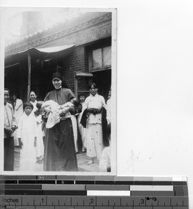 Maryknoll Sister holding twin babies at Dalian, China