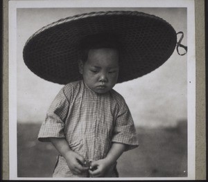 Boy with hat made of bamboo