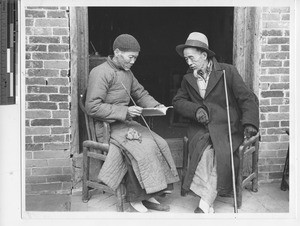 Two elders studying catechism at Wuzhou, China, 1948