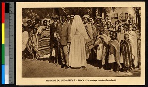 Groom and veiled bride gathered with a large crowd, South Africa, ca.1920-1940