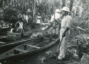 People loading pirogues, in Gabon