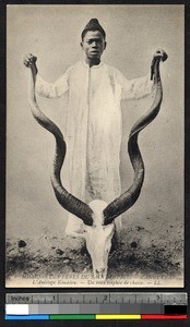 Child posed with antelope skull, Zanzibar, Tanzania, ca. 1920-1940