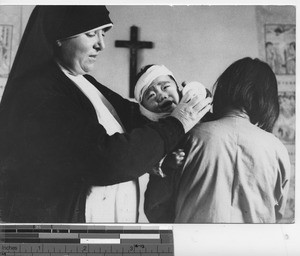 Sister M. Mercedes at dispensary at Fushun, China, 1938