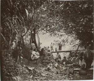 Girls of Rapa island preparing the 'popoï' (taro), in the middle of the river