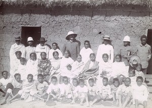 Missionary surrounded by a group of people, in Madagascar