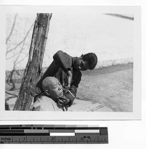 Man getting a shave in Guilin, China, 1947