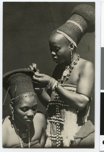 Two young women arranging their headdress, South Africa