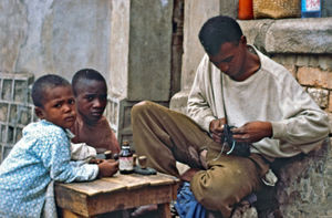 Mission at the bottom - City Mission in Madagascar. Old tires used by shoemakers in the manufac